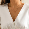 Collier long en Y à billes dorées – doré