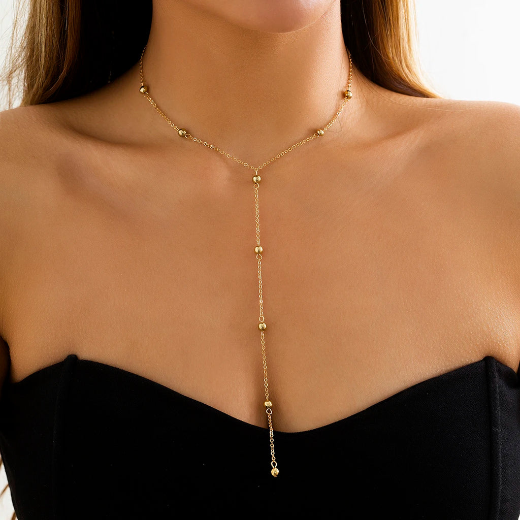 Collier long en Y à billes dorées